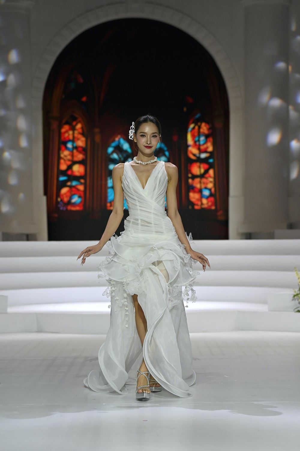 Show diễn nằm trong khuôn khổ tuần lễ thời trang Vietnam Couture Fashion Week - dự án khởi xướng bởi đạo diễn Long Kan - người đứng sau hàng loạt sàn diễn ấn tượng, kết hợp giữa thời trang và nghệ thuật. Không gian show diễn tràn ngập sắc trắng tinh khôi, hoa tươi gợi không gian lễ cưới cũng như thông điệp chủ đạo "When love walks the runway" của tuần lễ thời trang.