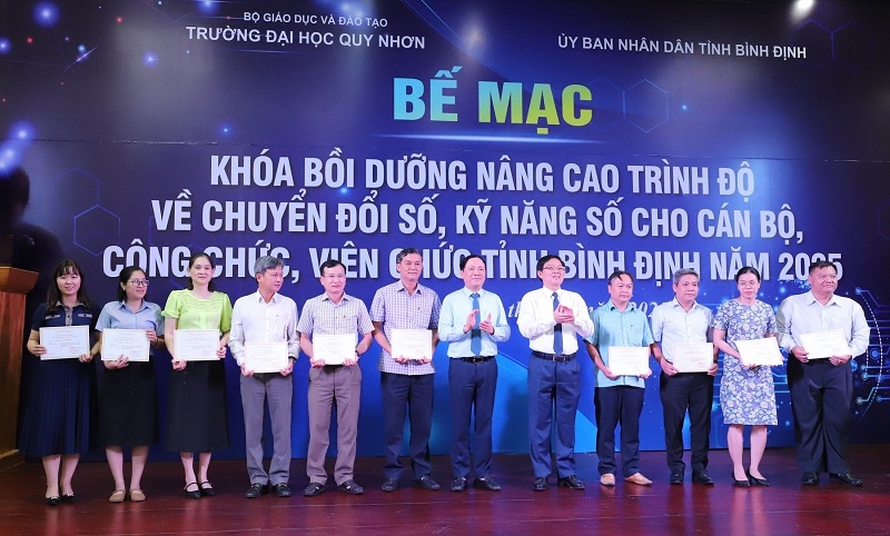 Bí thư Tỉnh uỷ Hồ Quốc Dũng (thứ 5 từ phải qua) và Chủ tịch UBND tỉnh Phạm Anh Tuấn (thứ 6 từ phải qua) trao giấy chứng nhận cho các cán bộ, công chức, viên chức đã hoàn thành khoá bồi dưỡng.