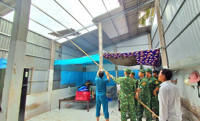 lực lượng công an xã giúp dân lợp lại mái nhà